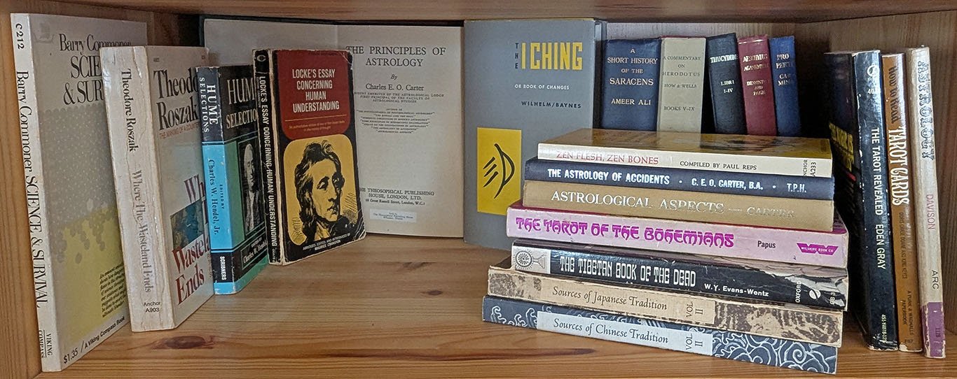 Different arrangements on a bookshelf of books from my adolescence include Barry Commoner's Science and Survival; Theodore Roszak's Where the Wasteland Ends; Locke's Essay Concerning Human Understanding (with the portrait I copied); three books on Astrology by Charles E.O. Carter along with others on the Tarot; the I Ching, The Tibetan Book of the Dead and other collections of East Asian texts; Ameer Ali's Short History of the Saracens; and several Greek and Latin texts including How and Wells Commentary on Herodotus and Aeschylus' Agamemnon with the commentary of Denniston and Page.